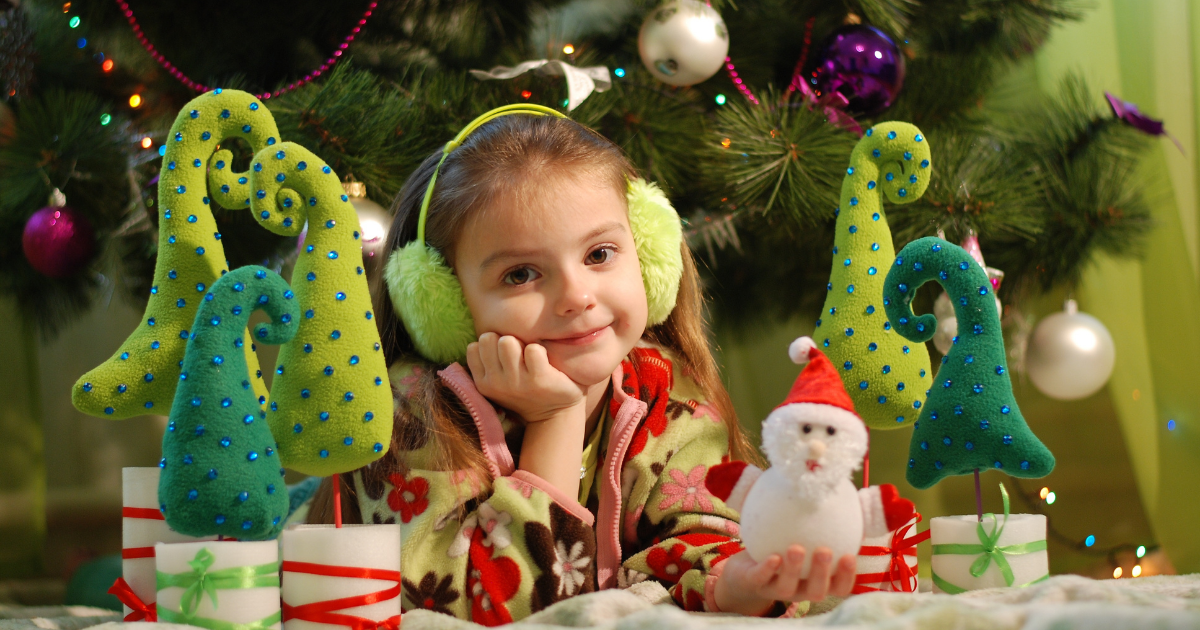 Young girl in front of Christmas tree